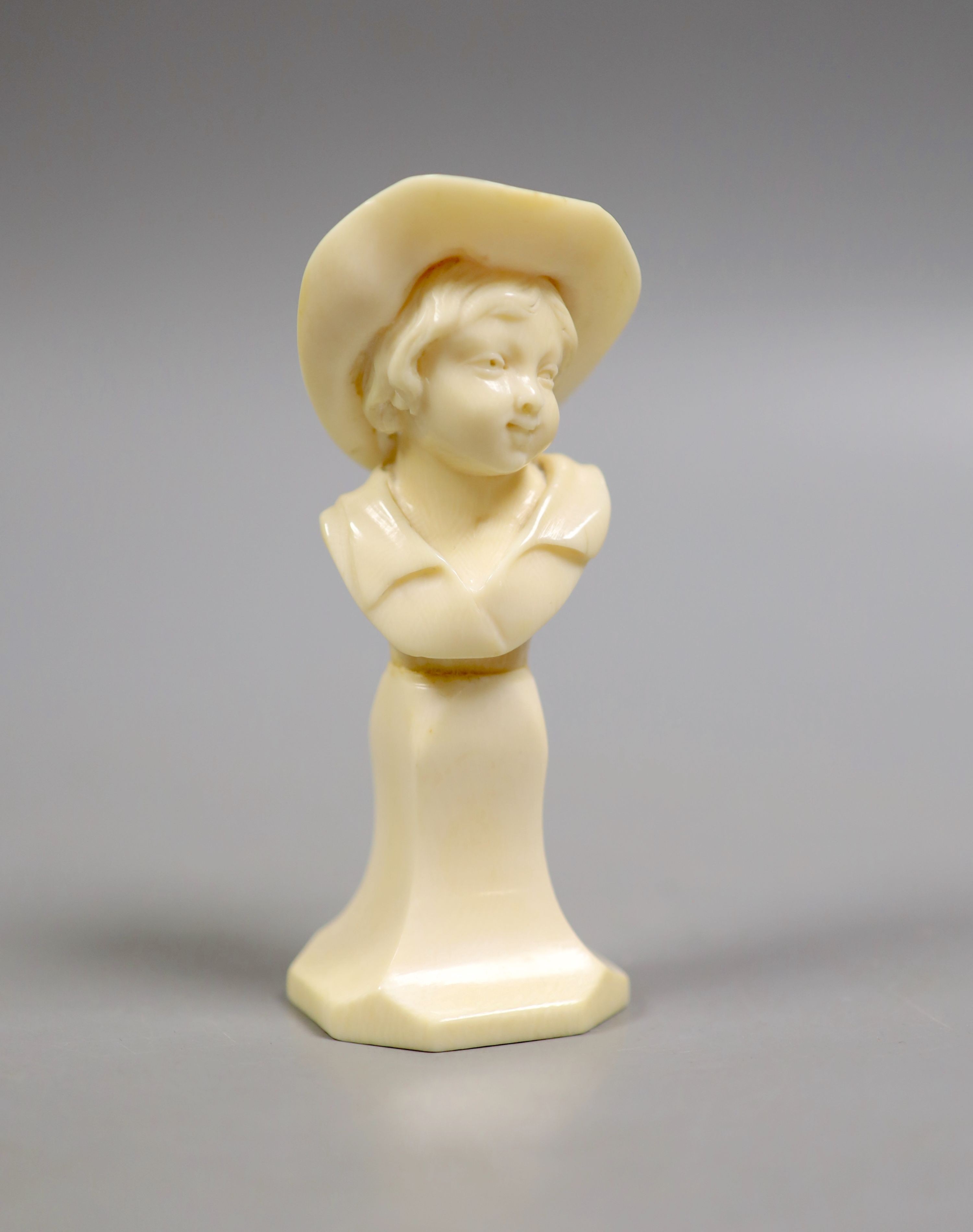 A carved ivory bust of a boy wearing a hat, early 20th century, 11.5 cm high